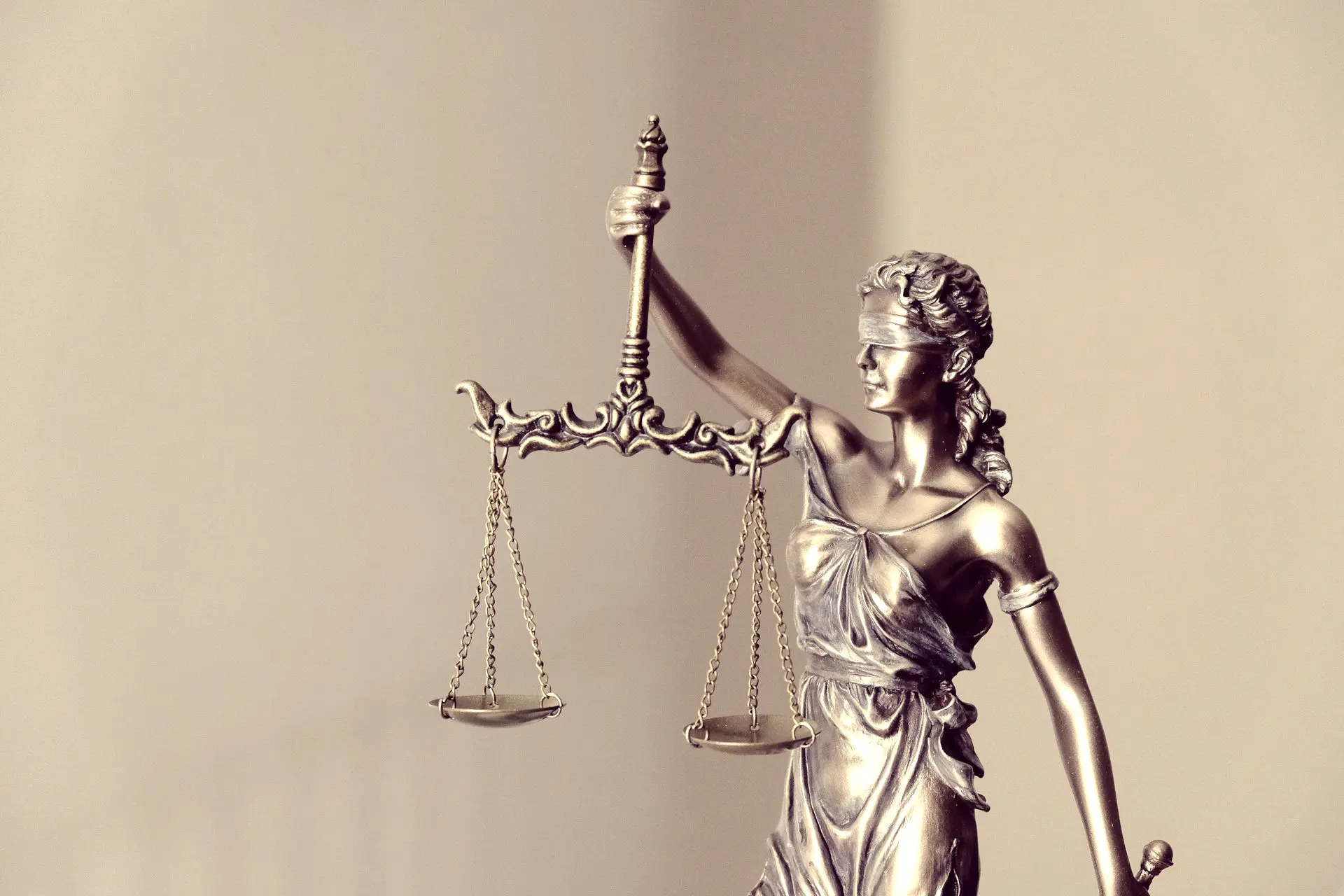 woman in dress holding sword figurine